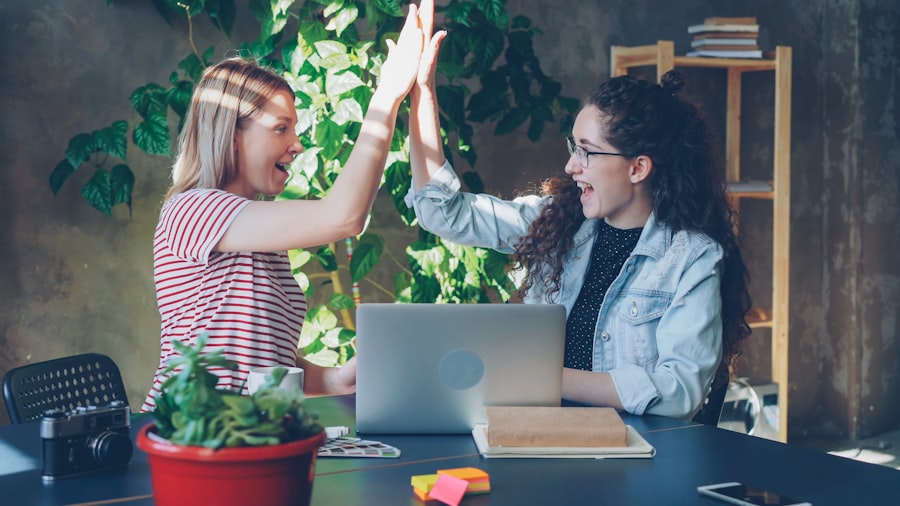 Two coworkers celebrating a delivery with a high five