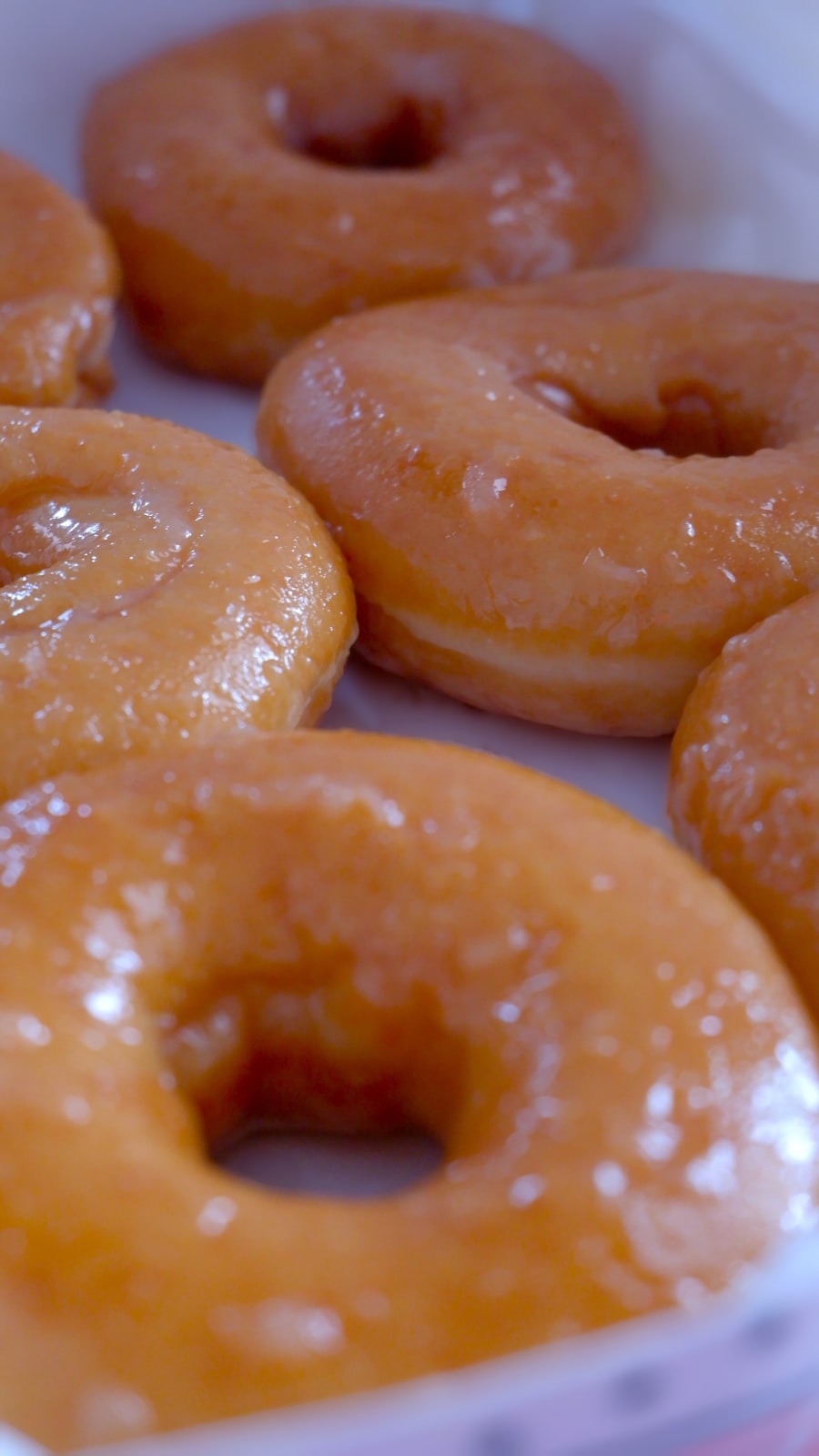 Close-up of an open box of glazed donuts