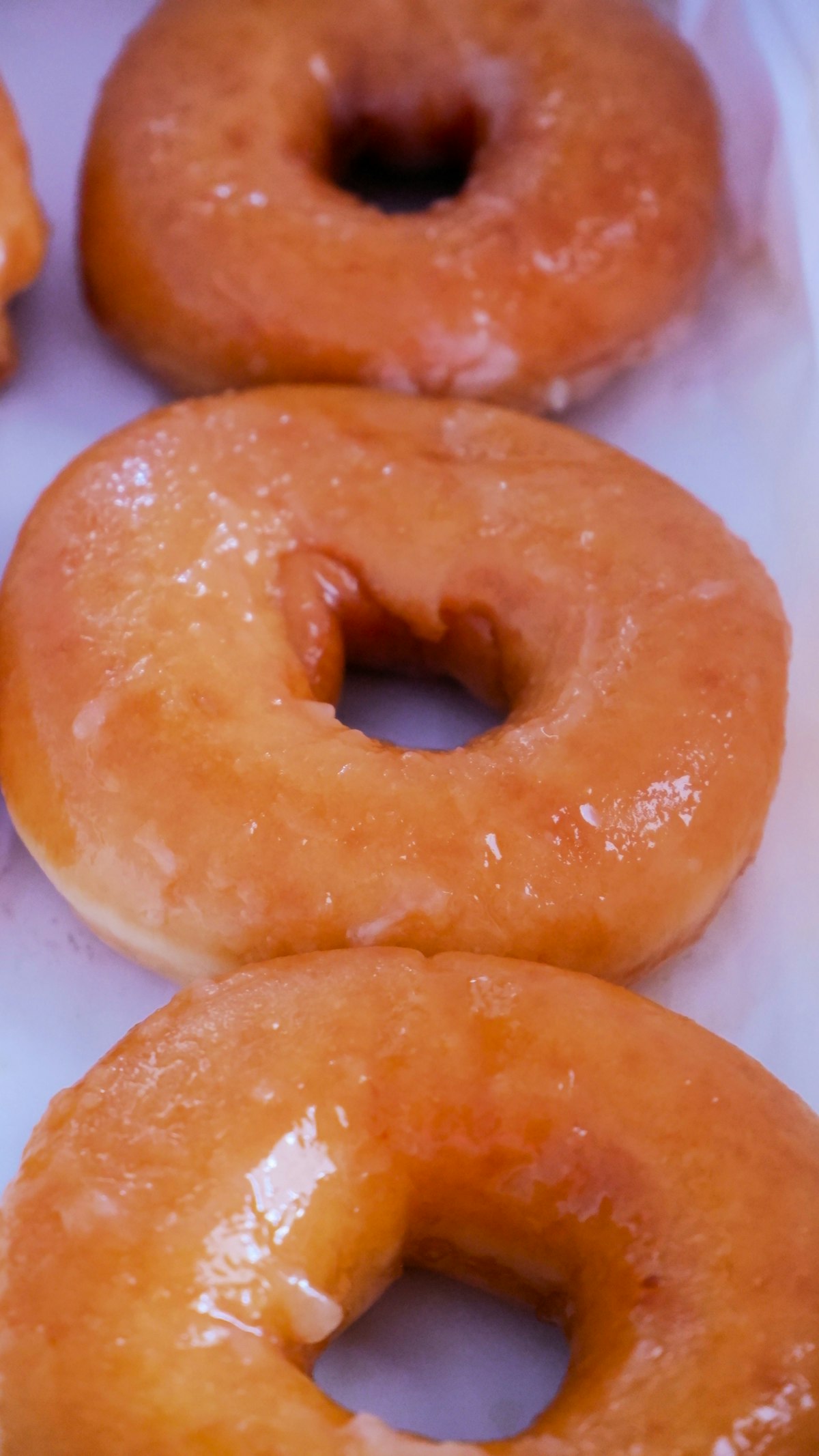Open box of donuts styled for a birthday gift reveal
