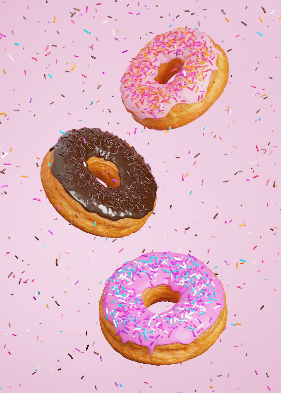 Three pink-frosted sprinkle donuts, the top of a color-sorted tower
