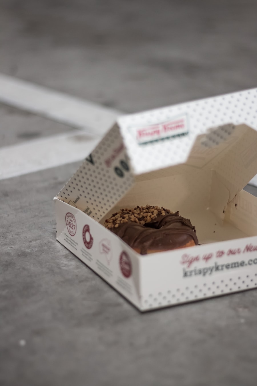 Chocolate-covered donut with its box, waiting as a surprise at home