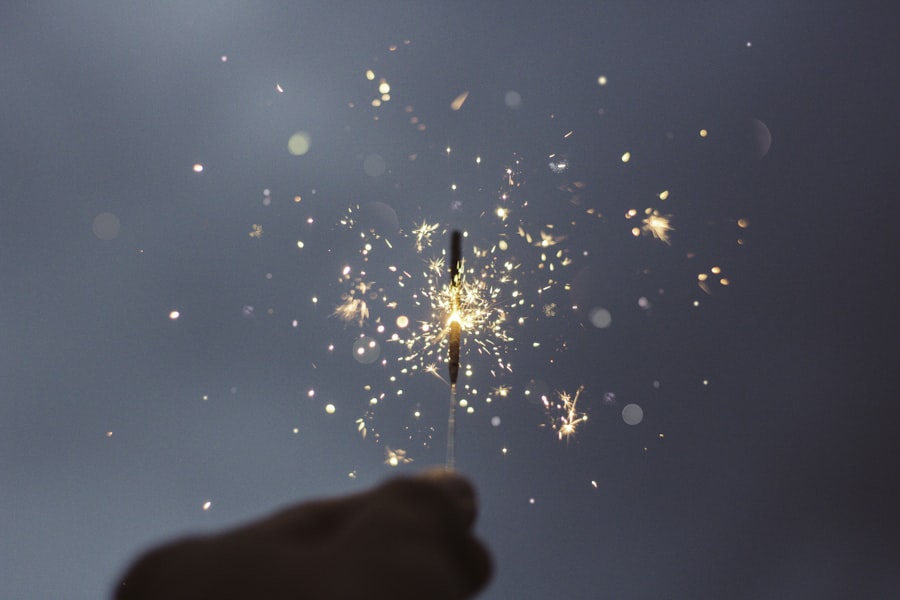 Hands holding lit sparklers for the singing moment