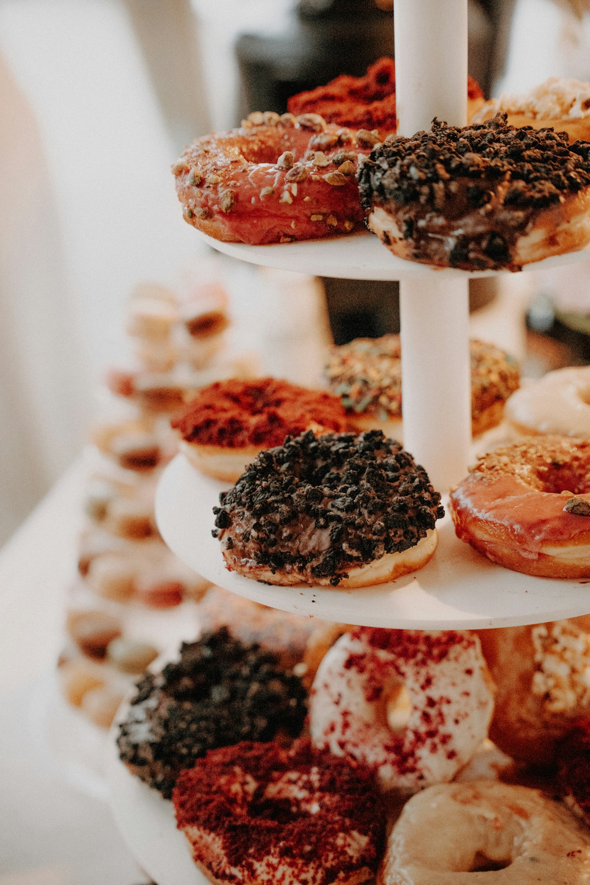 Colorful donuts arranged on a tiered stand as a party centerpiece