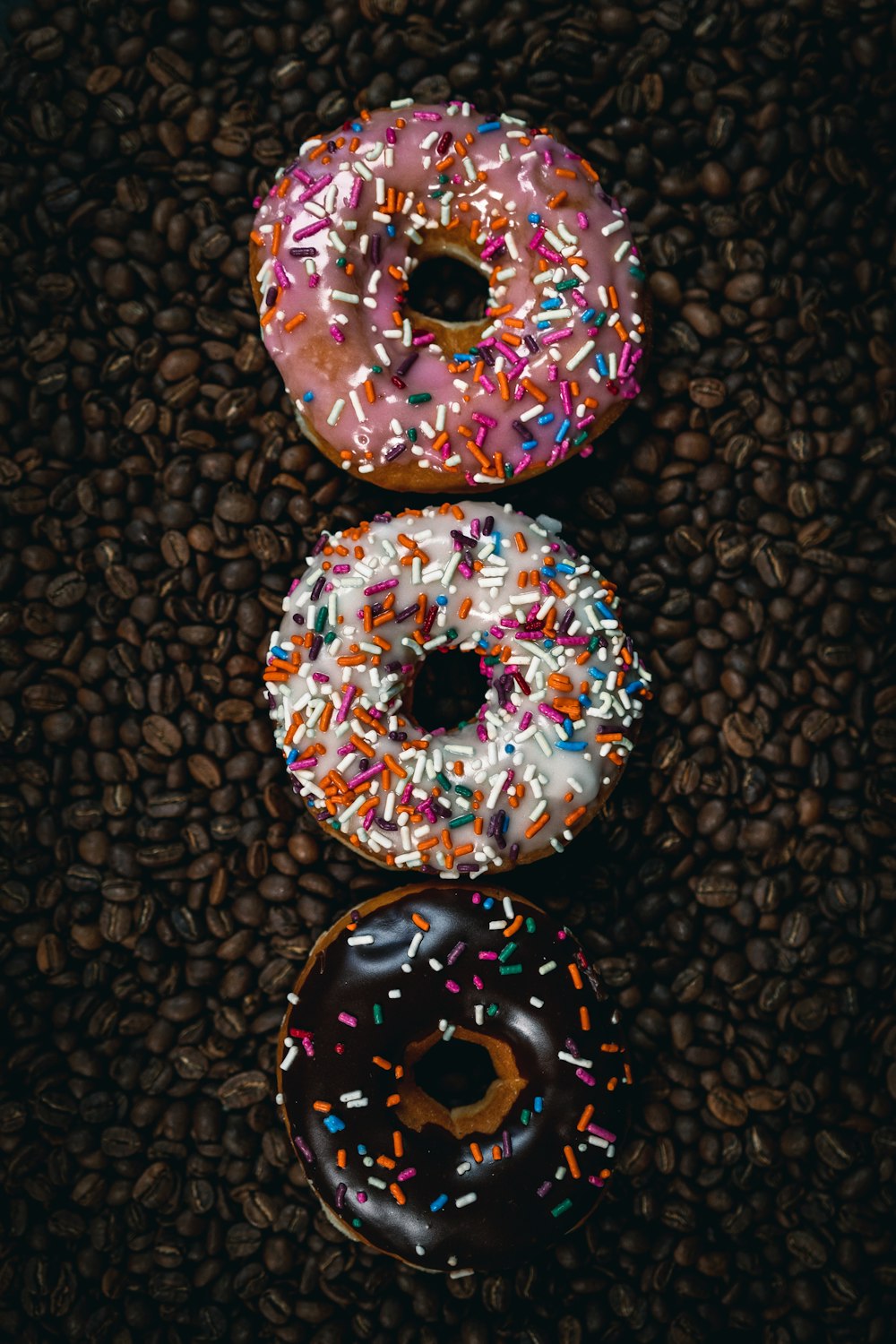 Sprinkle-covered donuts arranged close together