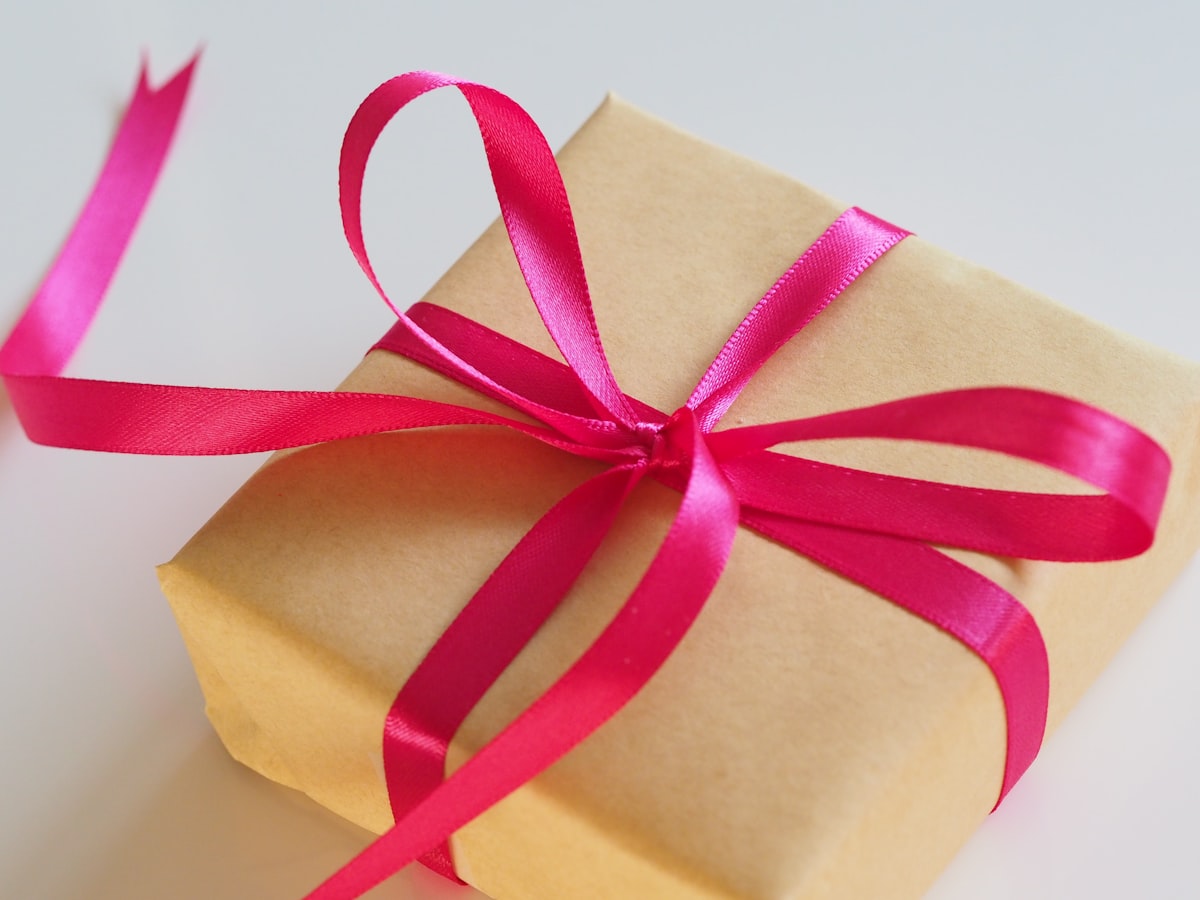 Gift box wrapped with a pink ribbon, ready to personalize