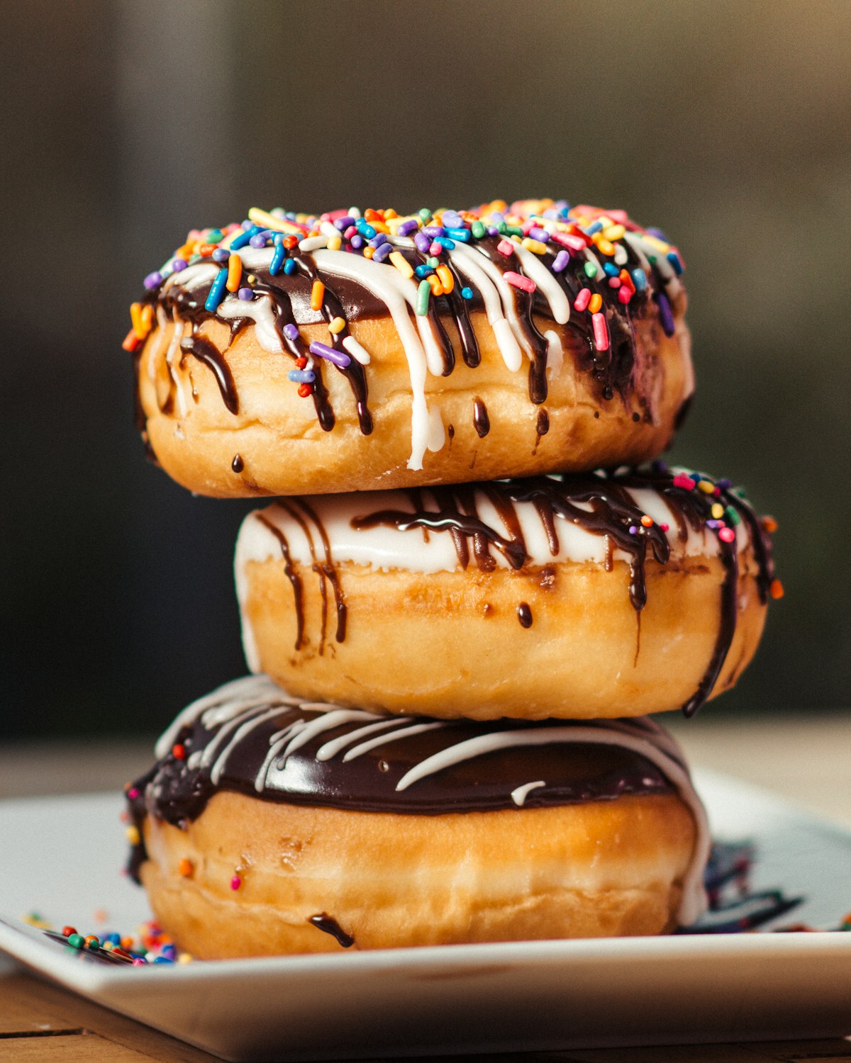 Chocolate donuts covered in rainbow sprinkles, the kind kids grab first