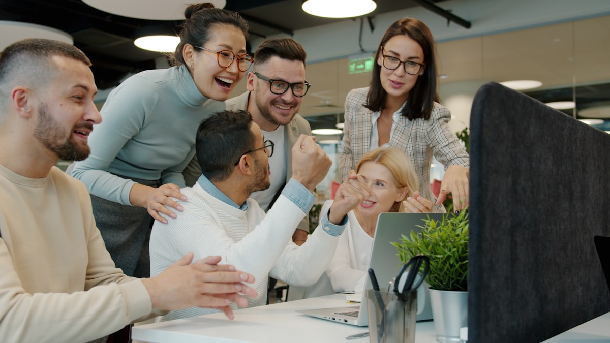 Team celebrating an employee birthday at their desks