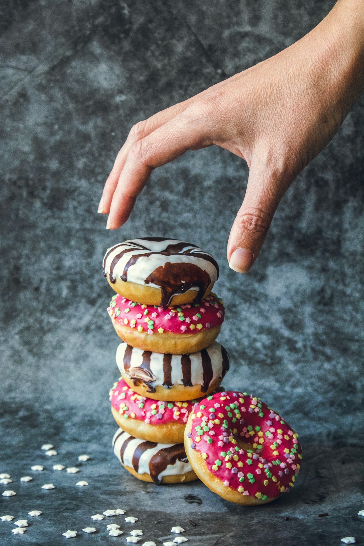 Donuts stacked in tiers for a birthday donut tower centerpiece